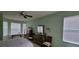 Inviting bedroom with multiple windows offering natural light, complemented by neutral walls and comfortable furnishings at 4467 Worthington Ct, Palm Harbor, FL 34685