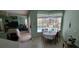 Dining Area featuring tile flooring, a view of a pool, and connected living space at 4467 Worthington Ct, Palm Harbor, FL 34685