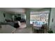 Dining Area featuring tile flooring, a view of a pool, and connected living space at 4467 Worthington Ct, Palm Harbor, FL 34685