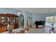Dining room showcasing a decorative cabinet, dining table, and a view of the pool through the sliding glass doors at 4467 Worthington Ct, Palm Harbor, FL 34685