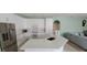 Modern kitchen with white cabinetry, quartz countertops, and stainless steel appliances at 4467 Worthington Ct, Palm Harbor, FL 34685
