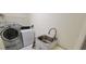 Bright laundry room with modern washer, dryer, and a utility sink for added convenience at 4467 Worthington Ct, Palm Harbor, FL 34685