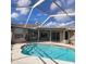 Backyard pool features a screened-in lanai, providing a perfect spot for relaxation and recreation at 4467 Worthington Ct, Palm Harbor, FL 34685