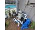 Outdoor pool equipment and plumbing, with plants and ground cover nearby at 4467 Worthington Ct, Palm Harbor, FL 34685