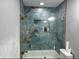 Bathroom with a tiled shower, tub, modern fixtures, glass door, and built-in storage niche at 4810 Chancellor Ne St, St Petersburg, FL 33703