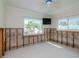 Bright bedroom with tile floors, frameless walls, and large windows offering ample natural light needing repair at 4810 Chancellor Ne St, St Petersburg, FL 33703
