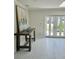 Bright entryway featuring elegant tile flooring, a stylish console table, and charming decor at 4810 Chancellor Ne St, St Petersburg, FL 33703