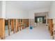 Open-concept living area with tile floors and framed-out walls, leading to additional living spaces, needing repair at 4810 Chancellor Ne St, St Petersburg, FL 33703