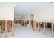 Spacious living room with white tile floors, framed-out drywall, and an open floor plan needing repair at 4810 Chancellor Ne St, St Petersburg, FL 33703