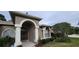 House exterior featuring arched entryway and landscaping at 4467 Worthington Ct, Palm Harbor, FL 34685