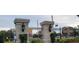 Community entrance with elegant pillars and signage at 4467 Worthington Ct, Palm Harbor, FL 34685