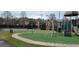 Community playground with play structures, swings, and basketball court at 4467 Worthington Ct, Palm Harbor, FL 34685