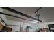 Garage with ceiling storage system and lighting at 4467 Worthington Ct, Palm Harbor, FL 34685