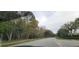 Residential street lined with lush trees at 4467 Worthington Ct, Palm Harbor, FL 34685