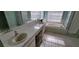 Bathroom with double sinks, garden tub, and separate shower at 4467 Worthington Ct, Palm Harbor, FL 34685