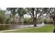 Calm pond, lush trees and fountain feature at 4467 Worthington Ct, Palm Harbor, FL 34685