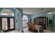 Bright dining room with a large wooden china cabinet and table set for a meal at 4467 Worthington Ct, Palm Harbor, FL 34685