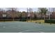Outdoor basketball court with two hoops, near a pond at 4467 Worthington Ct, Palm Harbor, FL 34685