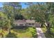 Aerial view of a single-story house with a large yard and mature trees at 1765 Thames St, Clearwater, FL 33755