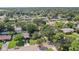 Aerial view of a single-story house with a large yard and mature trees at 1765 Thames St, Clearwater, FL 33755