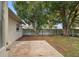 Large backyard patio with mature trees and a privacy fence at 1765 Thames St, Clearwater, FL 33755