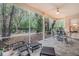 Relaxing screened porch with tiled floor and seating area at 2202 Green Oaks Ln, Tampa, FL 33612