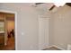 Bedroom with closet, door to another room, and ceiling fan at 13461 Marble Sands Ct, Hudson, FL 34669