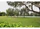 Community pickleball court with bench and landscaping at 13461 Marble Sands Ct, Hudson, FL 34669