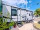 White travel trailer with black accents parked on a paved driveway at 4810 Chancellor Ne St, St Petersburg, FL 33703