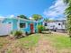 Charming teal house with coral front door and manicured landscaping at 4810 Chancellor Ne St, St Petersburg, FL 33703