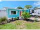 Cute teal home with coral door, RV parking, and well-maintained lawn at 4810 Chancellor Ne St, St Petersburg, FL 33703
