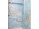 Shower with blue marble tile and gold fixtures at 4810 Chancellor Ne St, St Petersburg, FL 33703