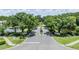 Community entrance with lush landscaping and ponds at 3399 Mermoor Dr # 207, Palm Harbor, FL 34685