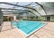 Inviting community pool area with screened enclosure at 3399 Mermoor Dr # 207, Palm Harbor, FL 34685