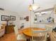 Condo dining area with round table and four chairs, open to kitchen at 3399 Mermoor Dr # 207, Palm Harbor, FL 34685