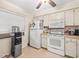 Condo kitchen with white appliances and ample counter space at 3399 Mermoor Dr # 207, Palm Harbor, FL 34685