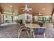 Covered patio with tables and chairs near the pool at 3399 Mermoor Dr # 207, Palm Harbor, FL 34685