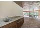 Outdoor kitchen area by the pool with granite countertop at 3399 Mermoor Dr # 207, Palm Harbor, FL 34685