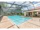 Community pool with covered patio and seating area at 3399 Mermoor Dr # 207, Palm Harbor, FL 34685