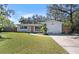 Front view of house with lawn and driveway at 1817 E 109Th Ave, Tampa, FL 33612