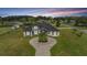 Stunning two-story home with a circular driveway at dusk at 3461 Sierra Nevada Dr, Brooksville, FL 34602