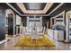 Elegant dining room with white chairs, yellow rug, and black walls at 3461 Sierra Nevada Dr, Brooksville, FL 34602