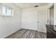 Bright bedroom with wood-look floors and an open door to hallway at 11303 86Th Ave, Seminole, FL 33772