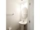 Clean and updated half bathroom with pedestal sink and oval mirror at 10823 Verawood Dr, Riverview, FL 33579