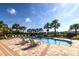 Community pool with lounge chairs and palm trees at 10823 Verawood Dr, Riverview, FL 33579