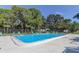 Community swimming pool with lounge chairs at 9537 86Th Ave # 9537, Seminole, FL 33777