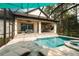 Enjoy this luxurious pool and spa, screened enclosure, and outdoor kitchen at 19554 Autumn Oak Ln, Brooksville, FL 34601