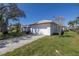 Attached garage with a white door and a wide driveway at 1973 Hawaii Ne Ave, St Petersburg, FL 33703