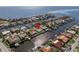 Aerial view of waterfront home with private dock, showcasing surrounding neighborhood and water access at 1973 Hawaii Ne Ave, St Petersburg, FL 33703