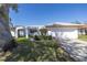 White single-story house with a two-car garage and mature landscaping at 1973 Hawaii Ne Ave, St Petersburg, FL 33703